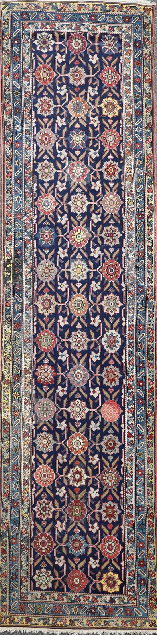 A Caucasian blue ground runner, 13ft 2in by 3ft 8in.